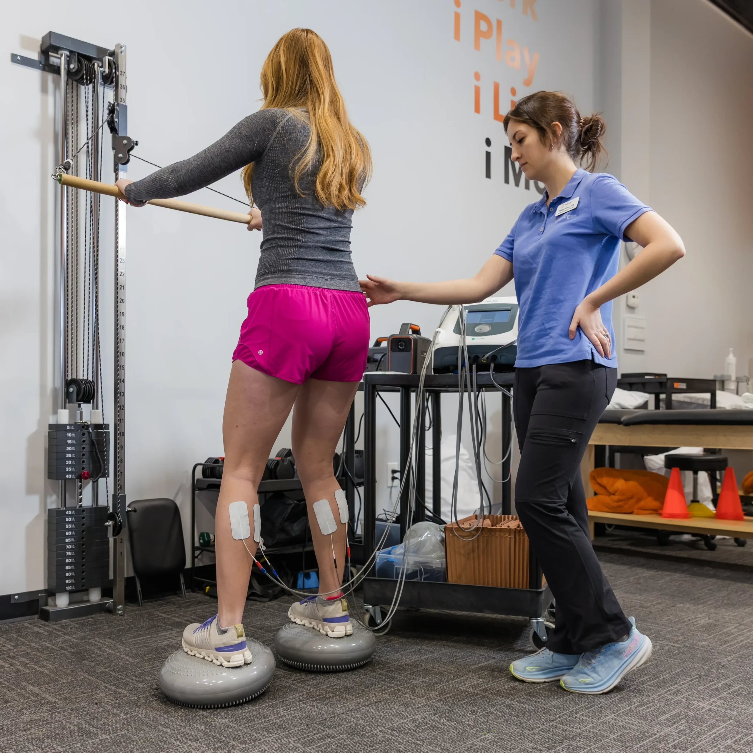 patient with iMove Physical Therapy doing a balance exercise with the Neubie to help her recovery